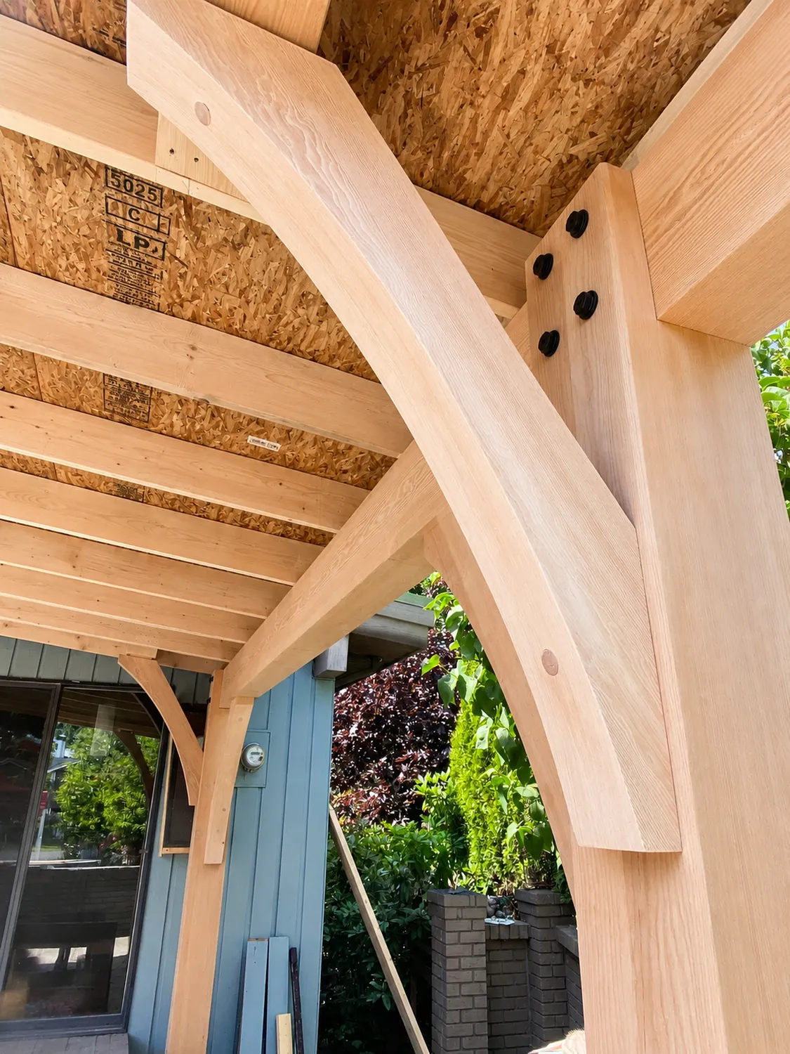 timber framing of pergula by Arama Building & Renovations in Qualicum Beach
